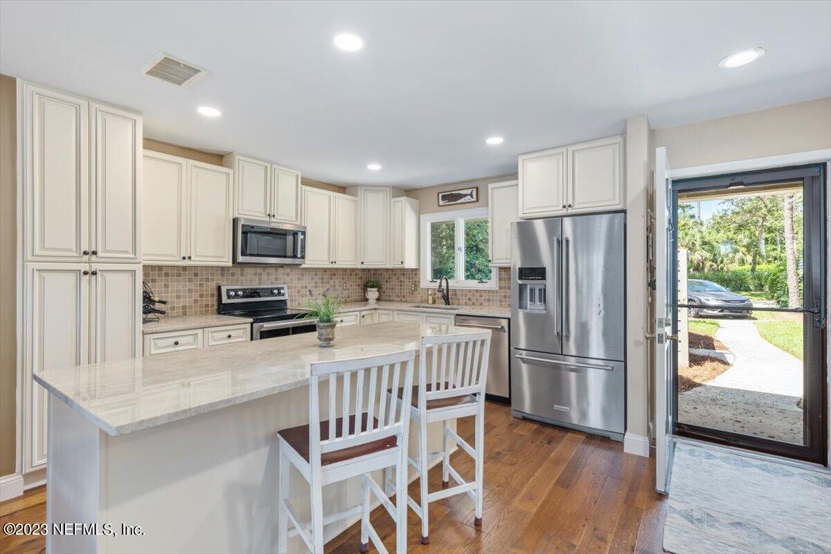 75 Fishermans Cove Road Ponte Vedra Beach, FL 32082 - Photo 5 of 47 a kitchen with white cabinets and stainless steel appliances
