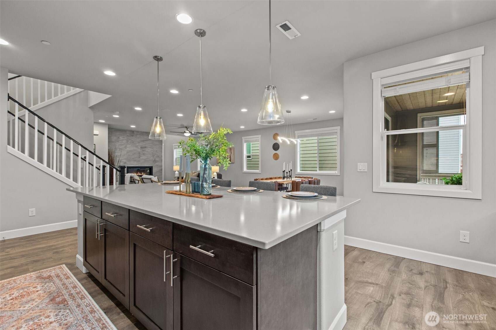 18231 3rd Drive Southeast Bothell, WA 98012 - Photo 10 of 40 a kitchen with kitchen island a sink and a stove with wooden floor