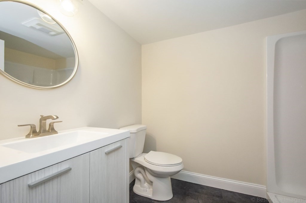 214 Riverside Drive Dedham, MA 02026 - Photo 13 of 26 a bathroom with a toilet a sink and mirror