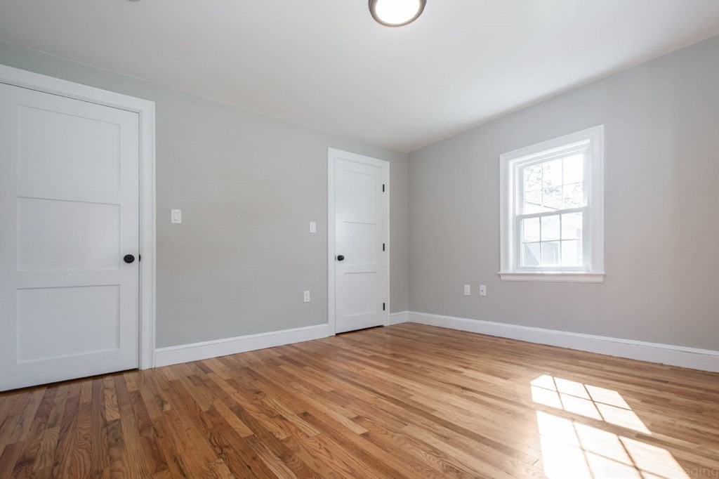 214 Riverside Drive Dedham, MA 02026 - Photo 15 of 26 a view of empty room with wooden floor and fan