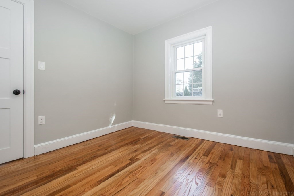 214 Riverside Drive Dedham, MA 02026 - Photo 16 of 26 an empty room with wooden floor and windows