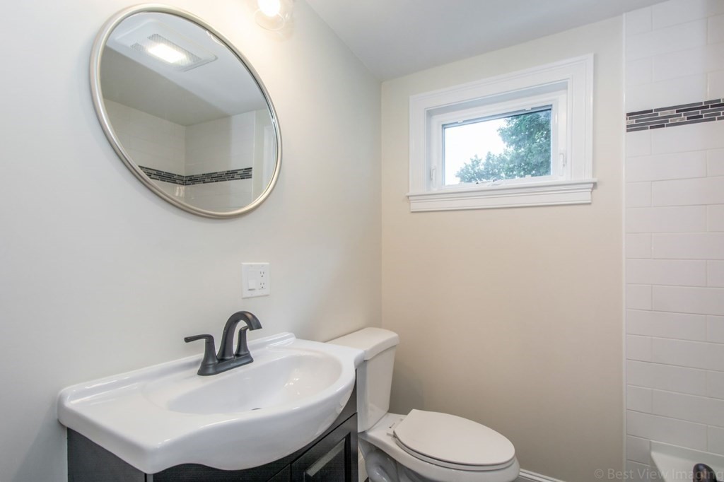 214 Riverside Drive Dedham, MA 02026 - Photo 22 of 26 a bathroom with a sink a mirror and a toilet