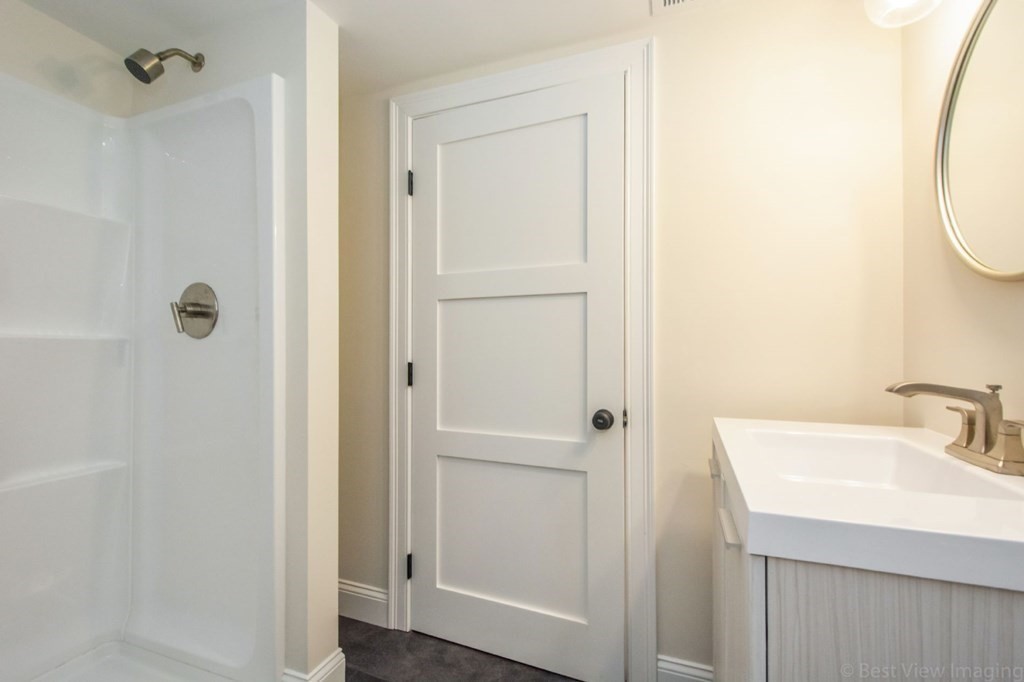 214 Riverside Drive Dedham, MA 02026 - Photo 23 of 26 a bathroom with a sink and a mirror