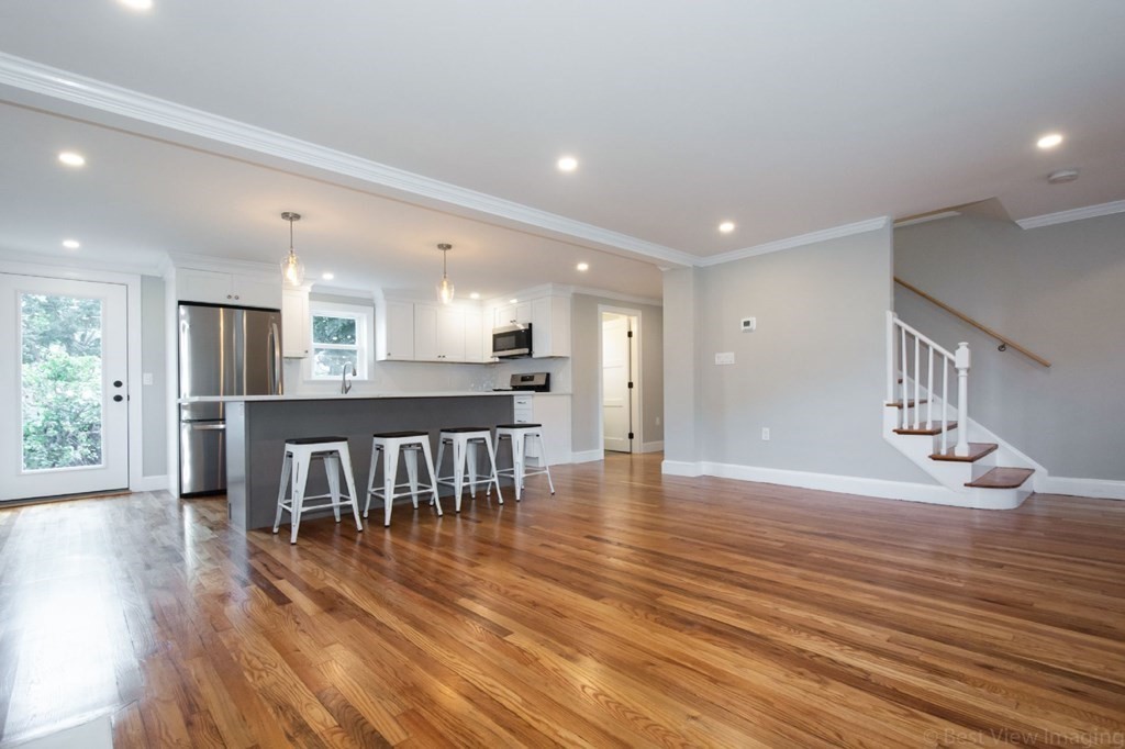 214 Riverside Drive Dedham, MA 02026 - Photo 8 of 26 an open kitchen with kitchen island and stainless steel appliances