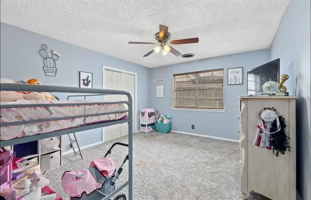 a bedroom with bed and a window