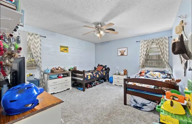 a bedroom with furniture and a baby crib