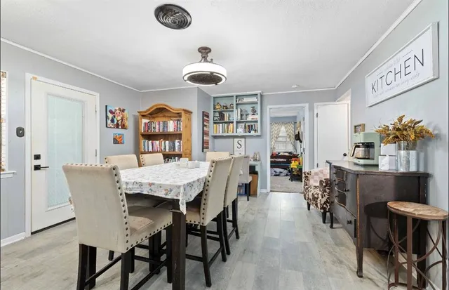 a view of a dining room with furniture and wooden floor