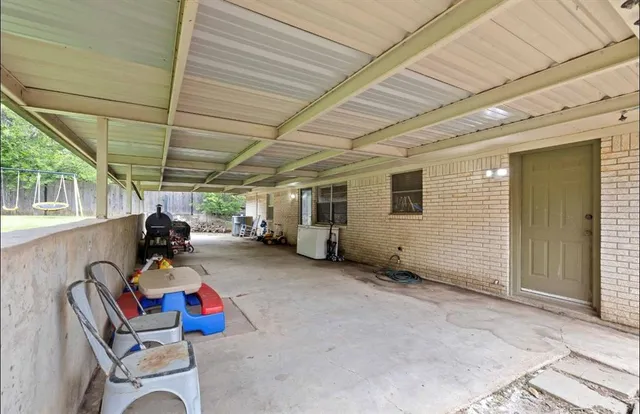 a view of a patio with table and chairs