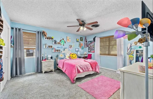 a bedroom with a bed dresser and a window