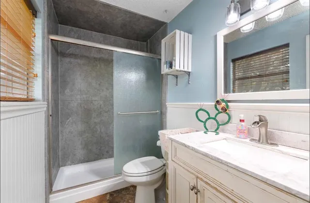 a bathroom with a sink toilet and shower