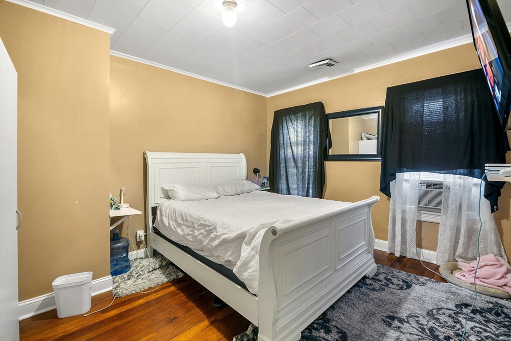 45-47 Bloomfield Street Springfield, MA 01108 - Photo 12 of 28 a bedroom with a bed and wooden floor