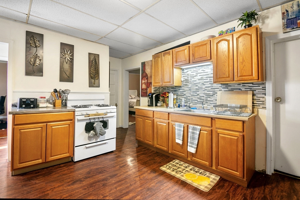 45-47 Bloomfield Street Springfield, MA 01108 - Photo 4 of 28 a kitchen with stainless steel appliances wooden floors and sink
