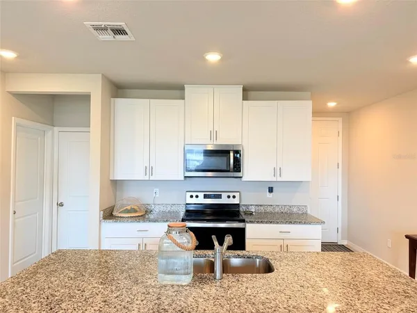 a living room with furniture a window and a flat screen tv