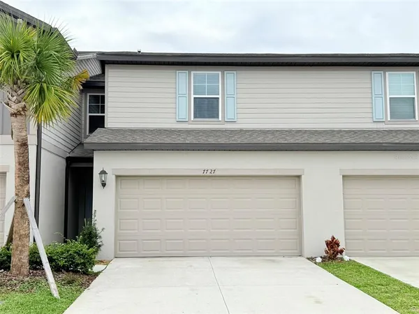 a front view of a house with garage