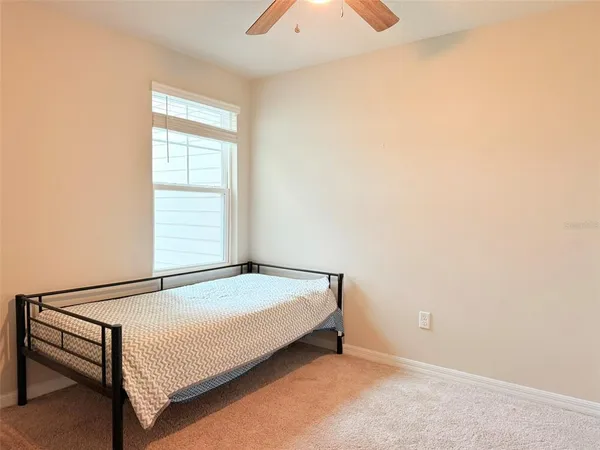 a living room with flat screen tv and a window