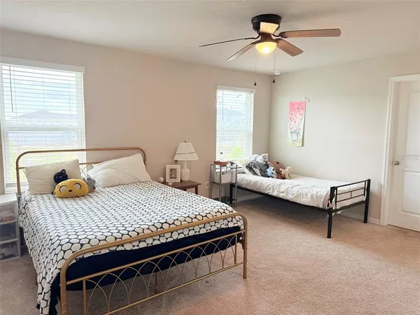 a bathroom with a granite countertop sink mirror and a toilet