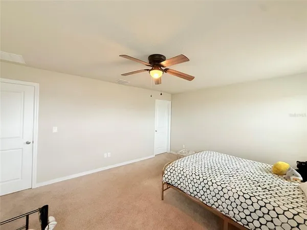 a bathroom with a granite countertop sink a toilet and a shower