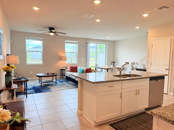 a kitchen with granite countertop a sink and cabinets