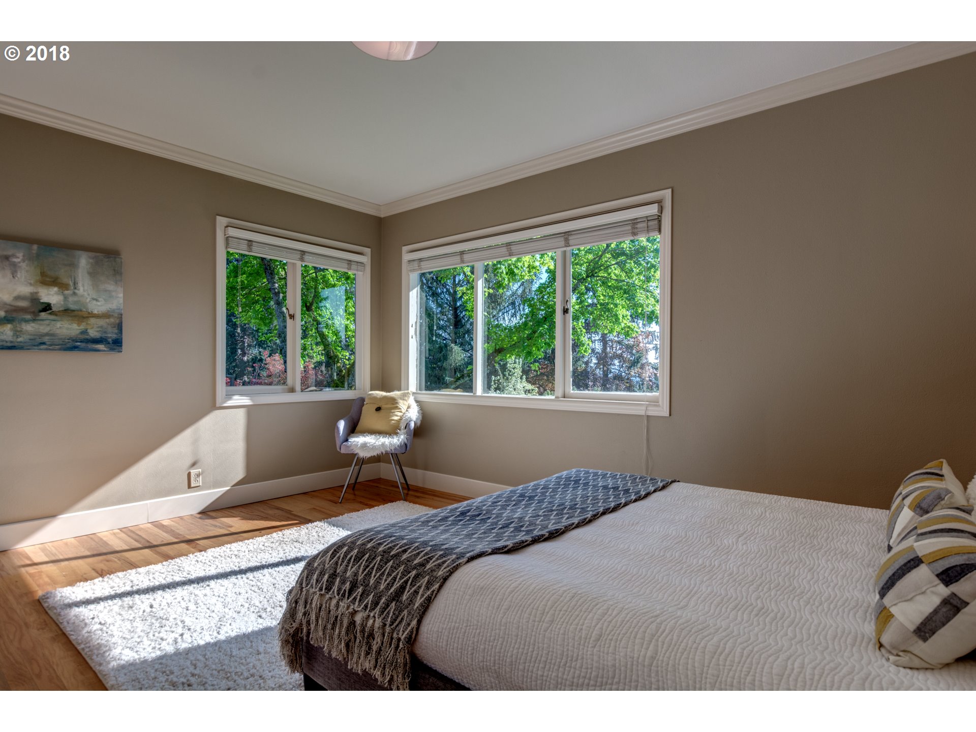 3925 Southwest Jerald Way Portland, OR 97221 - Photo 17 of 31 a bedroom with a bed and large windows