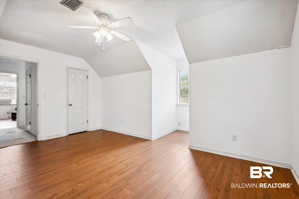 3616 Vista Ridge Drive Mobile, AL 36693 - Photo 16 of 20 Bonus room with ceiling fan, vaulted ceiling, a textured ceiling, and wood-type flooring