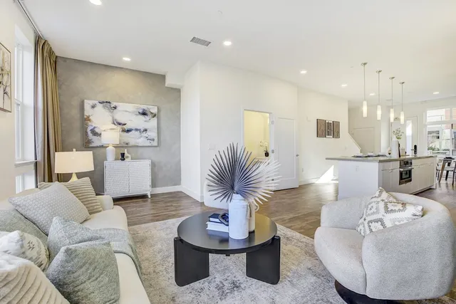 a living room with furniture and a potted plant