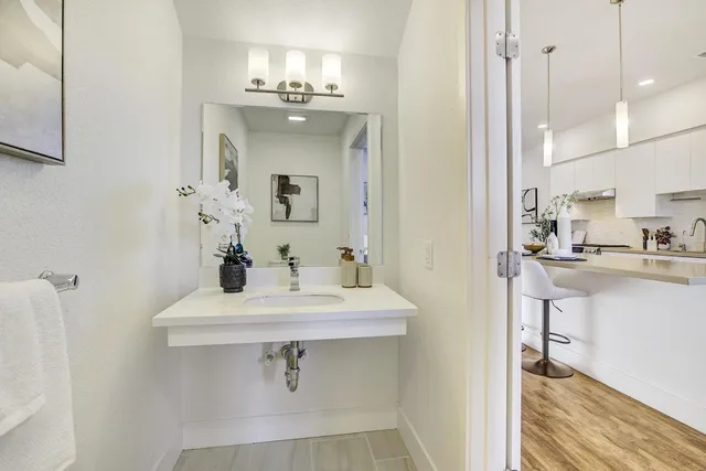a bathroom with a sink a mirror and shower