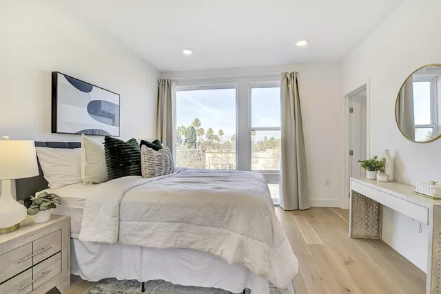 a spacious bedroom with a bed and a window