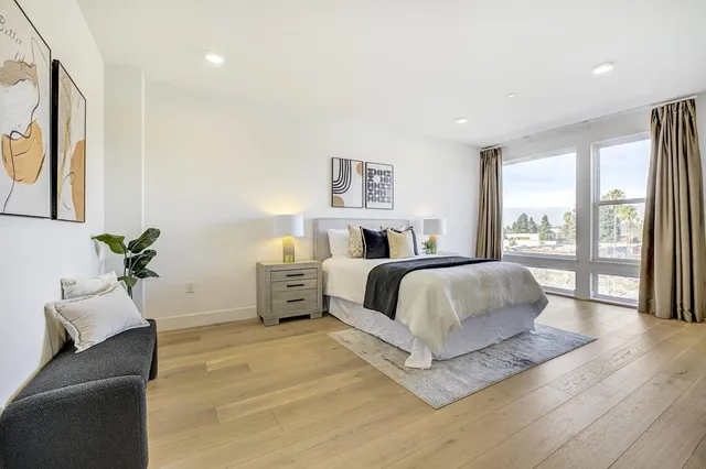 a spacious bedroom with a large bed and a couch