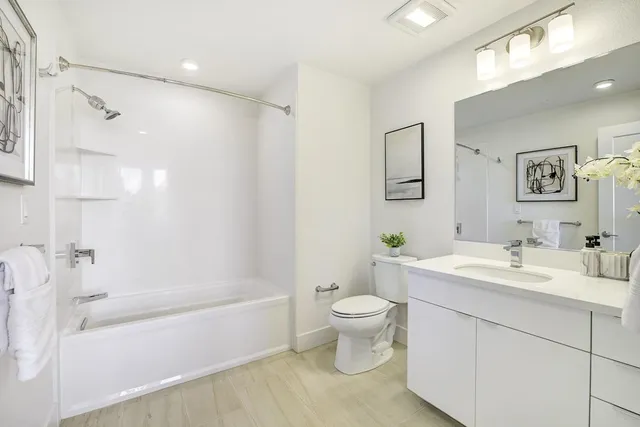 a bathroom with a white toilet sitting next to a bathroom sink and a bathtub