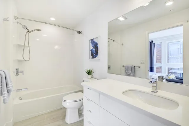 a bathroom with a sink toilet tub and shower