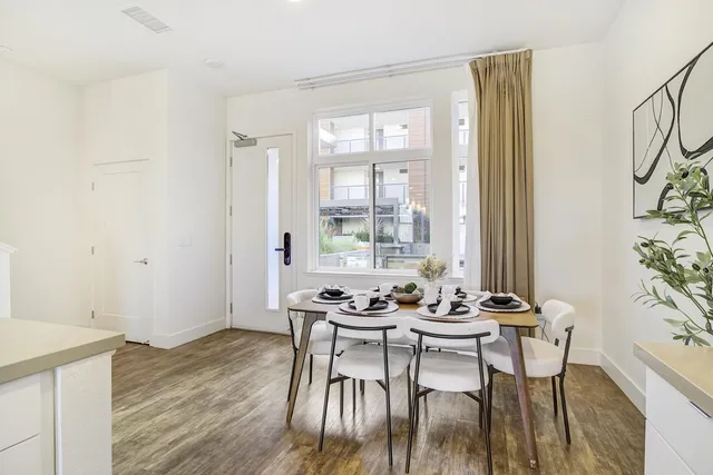 a dining room with furniture and wooden floor
