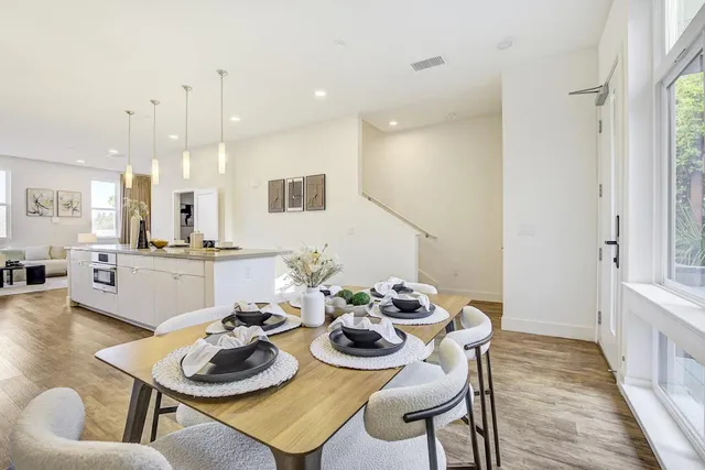 a dining room with furniture and a kitchen view