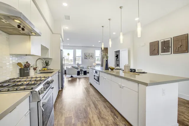 a kitchen with stainless steel appliances a stove sink and cabinets