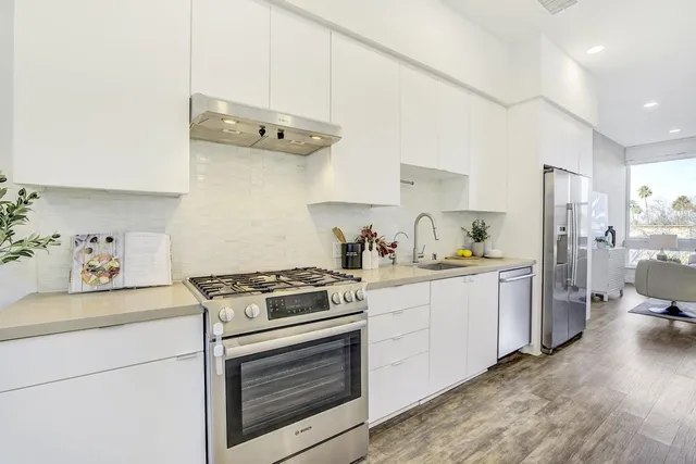 a kitchen with a stove oven and white cabinets