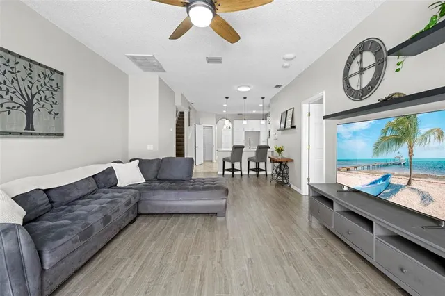 a living room with furniture and wooden floor