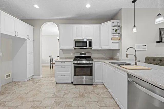a bathroom with a double vanity sink a mirror and a bathtub