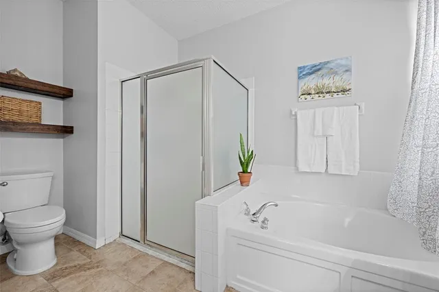 a bedroom with a bed and a ceiling fan