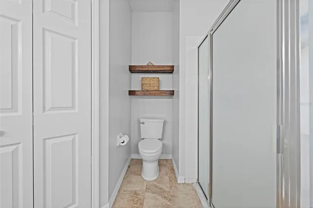 a view of a hallway with wooden floor and entryway