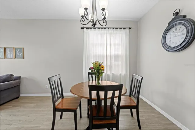 a dining room with furniture a livingroom and chandelier