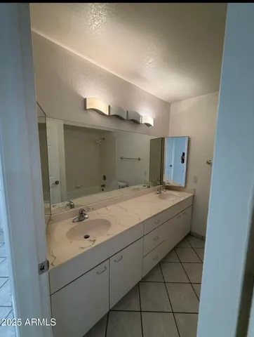 a bathroom with a sink and mirror