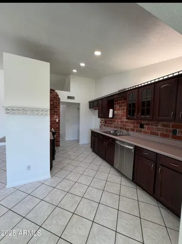 a large kitchen with a sink and cabinets