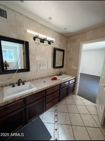a bathroom with a sink a mirror and a toilet