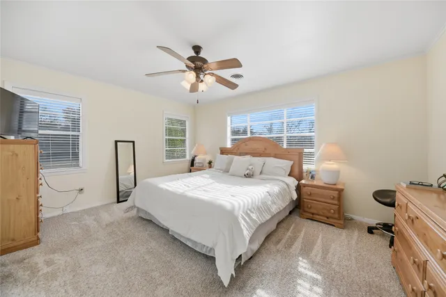 a bedroom with a bed dresser and a window