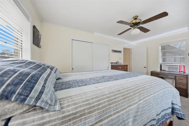 a bedroom with a bed and window