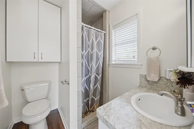 a bathroom with a sink a toilet and a mirror