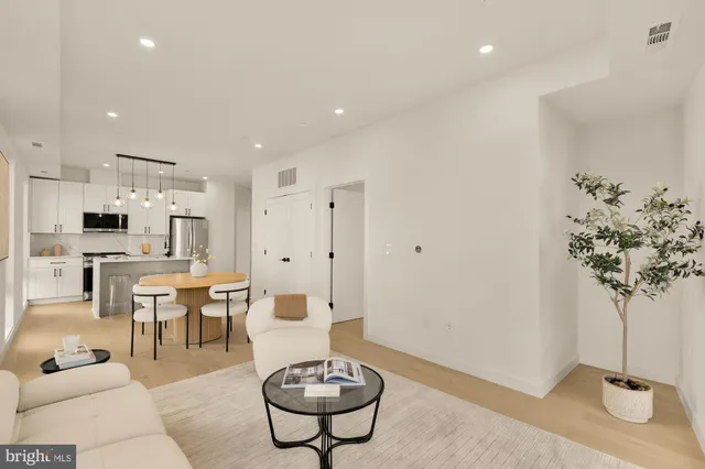 a living room with furniture a table and a potted plant