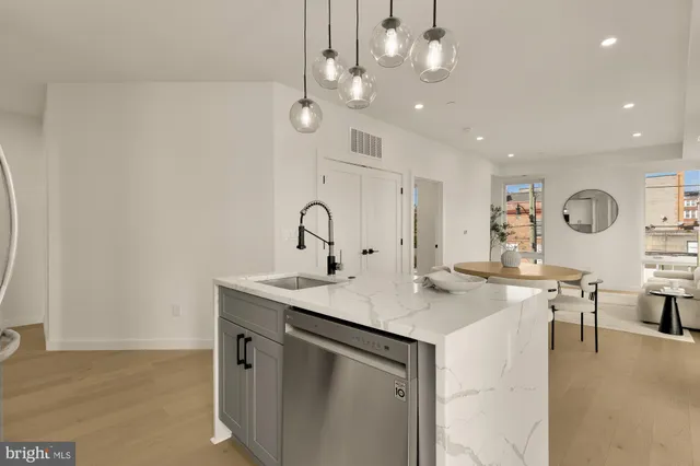 a view of a kitchen counter space a sink and chairs