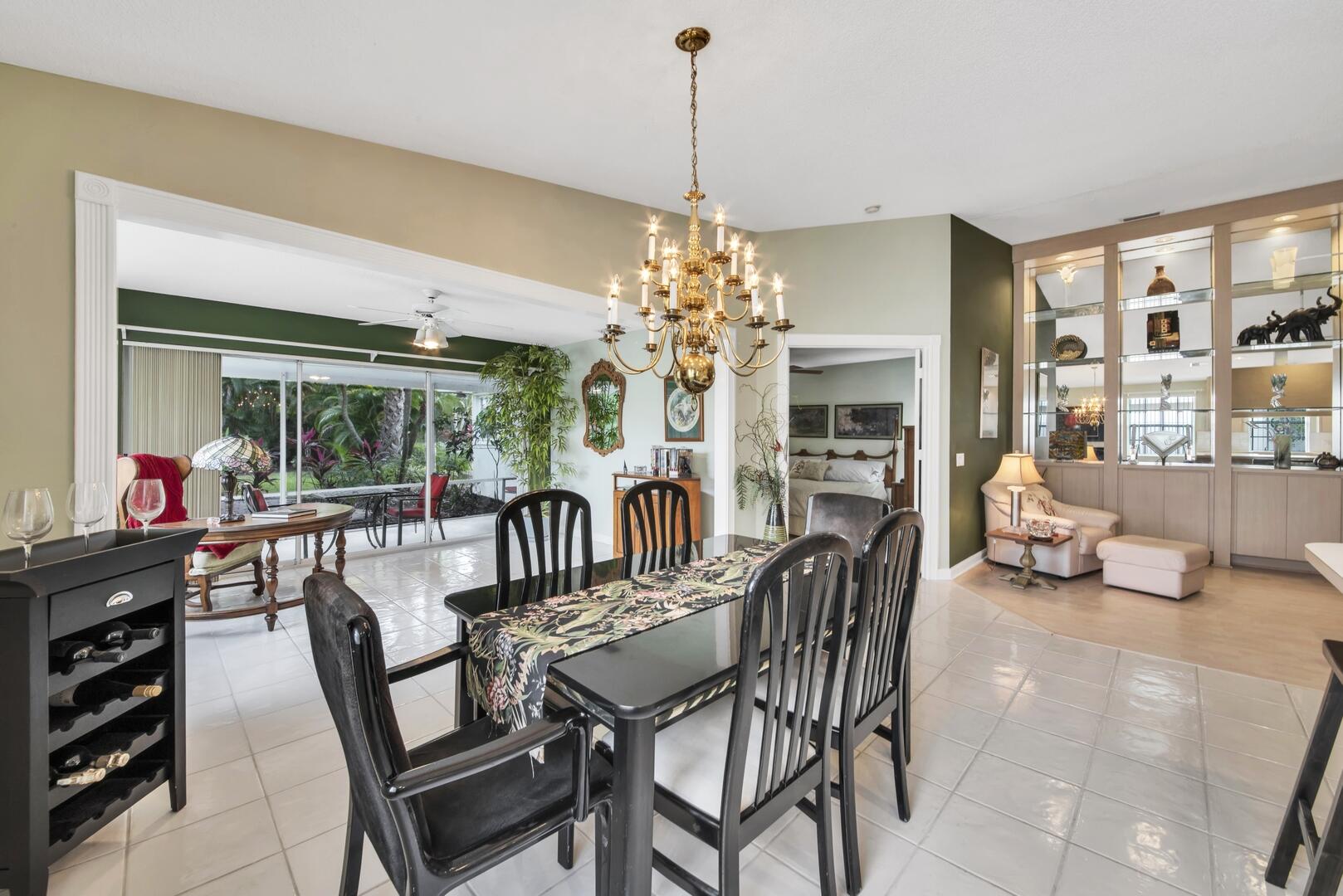 4220 Royal Oak Drive Palm Beach Gardens, FL 33410 - Photo 35 of 35 a dining room with furniture a chandelier and window