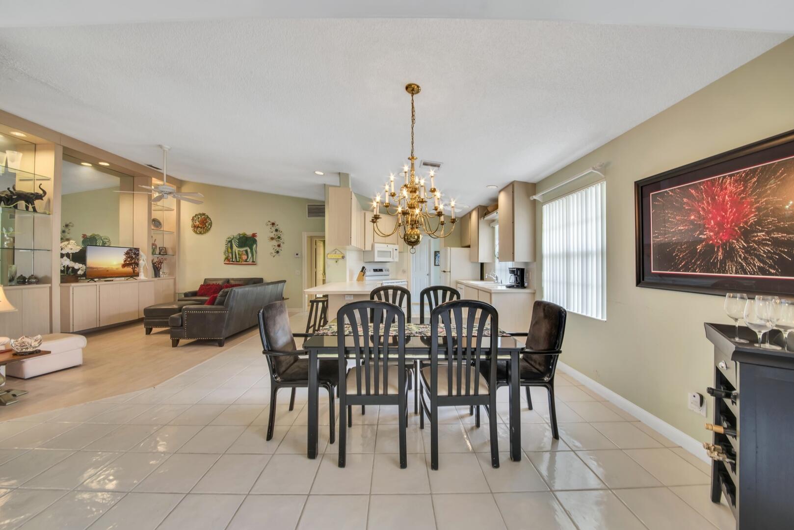 4220 Royal Oak Drive Palm Beach Gardens, FL 33410 - Photo 10 of 35 a view of a livingroom with furniture and a chandelier
