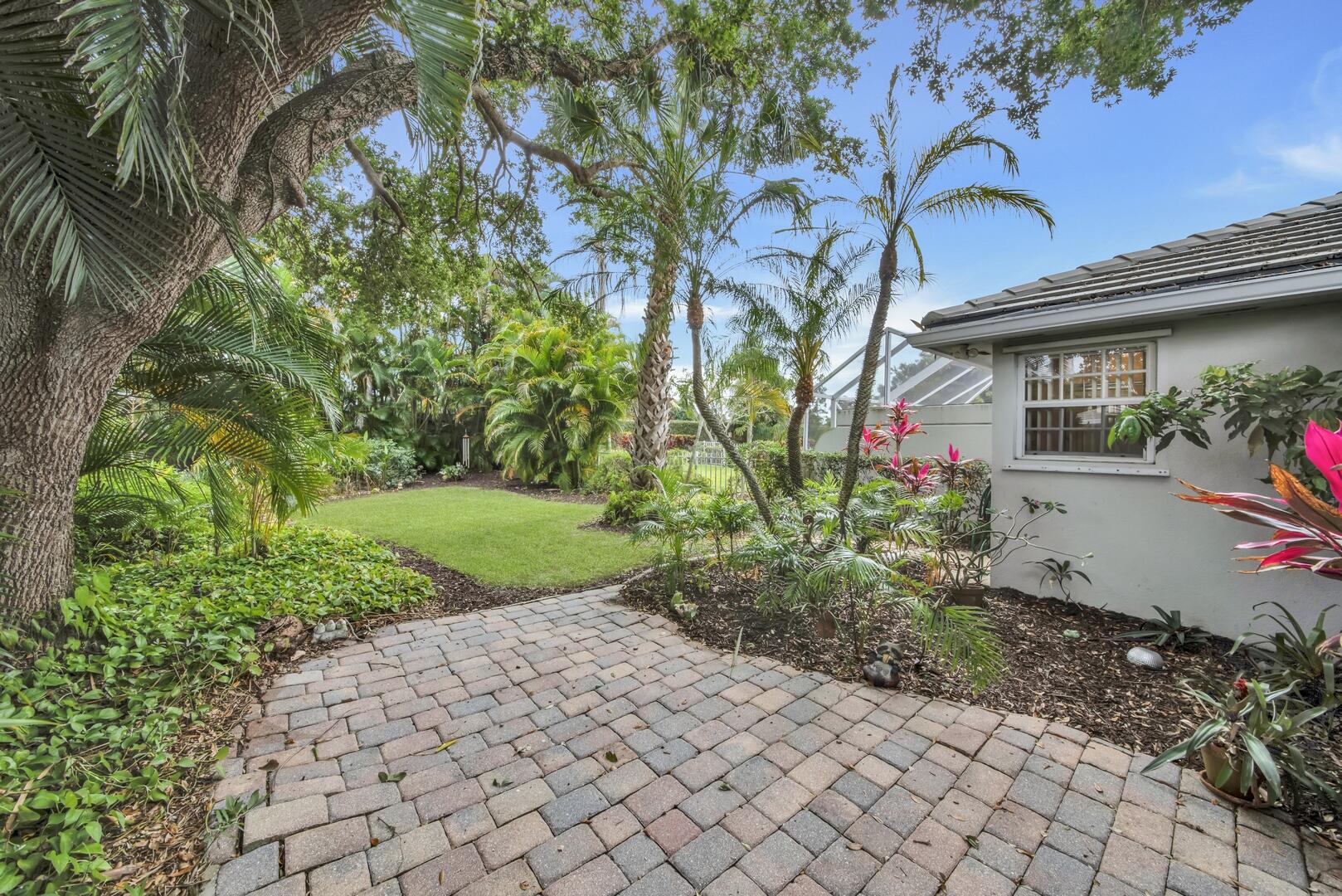 4220 Royal Oak Drive Palm Beach Gardens, FL 33410 - Photo 20 of 35 a front view of a house with garden